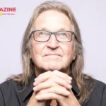 George Jung, known as Boston George, photographed in his later years wearing glasses and a black shirt