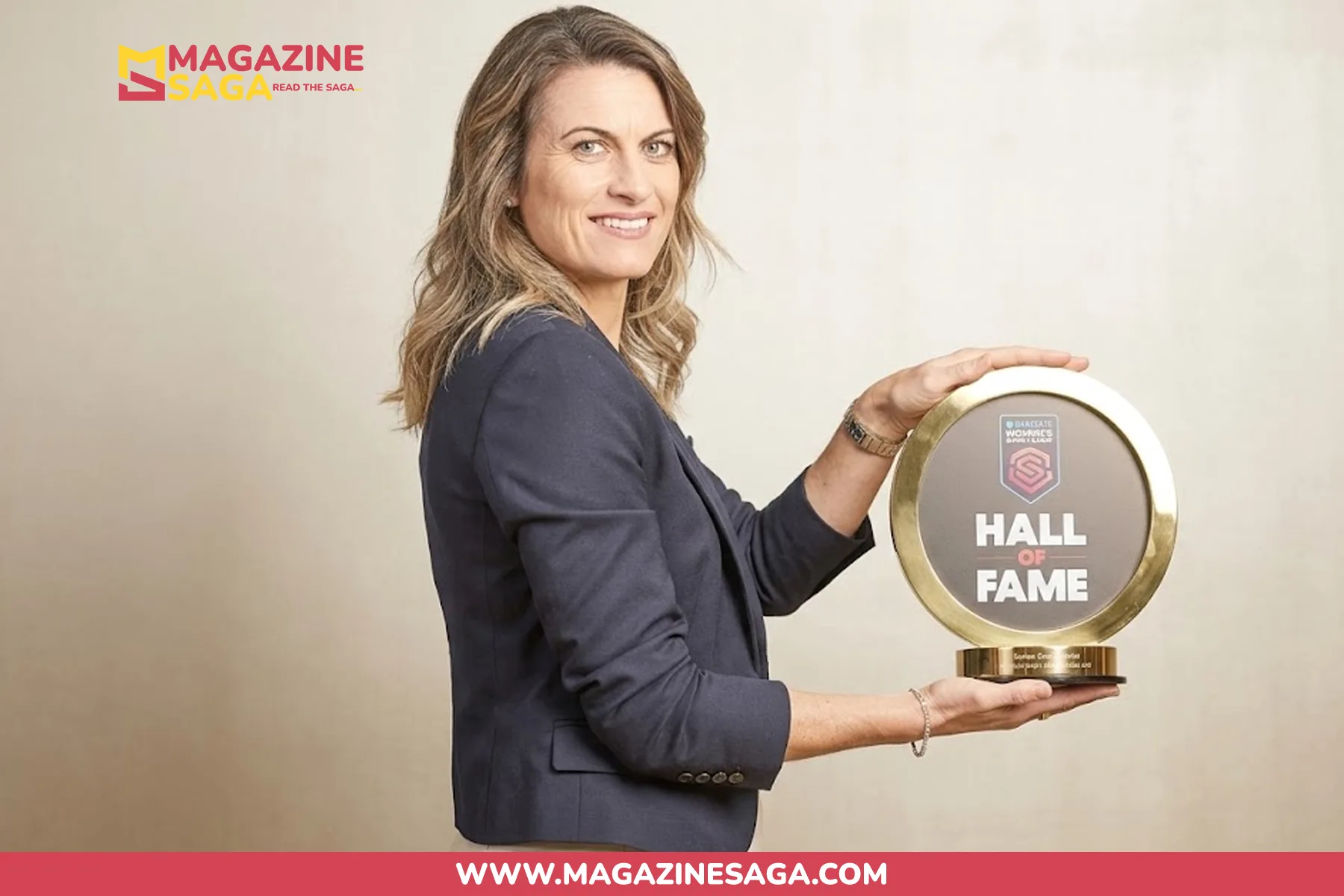 Karen Carney holding her WSL Hall of Fame trophy, awarded for her contribution to women's football in England