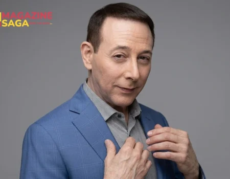 Paul Reubens, actor and comedian who created Pee-wee Herman, wearing a blue blazer in a professional portrait