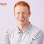 Reed Cross Howard smiling, wearing a grey polo shirt - son of Ron Howard and professional golfer
