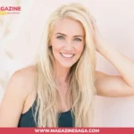 Ingrid Rinck Herbert smiling in a fitness shoot, wearing a dark tank top against a light pink background
