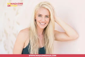 Ingrid Rinck Herbert smiling in a fitness shoot, wearing a dark tank top against a light pink background