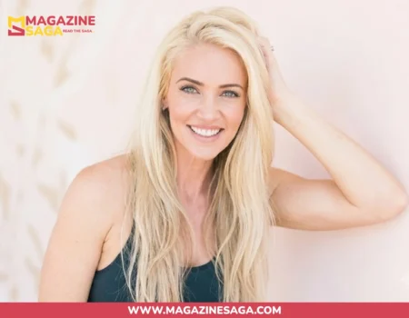 Ingrid Rinck Herbert smiling in a fitness shoot, wearing a dark tank top against a light pink background