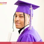 Isaiah Rahsaan Iverson in purple graduation cap and gown holding a diploma at his 2022 high school graduation