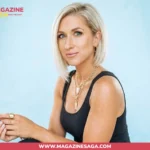 Kalee Rogers smiling in a black tank top against a light blue backdrop, gold jewelry visible