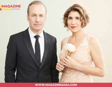 Naomi Yomtov and Bob Odenkirk posing together at a formal event, Naomi holding a white rose