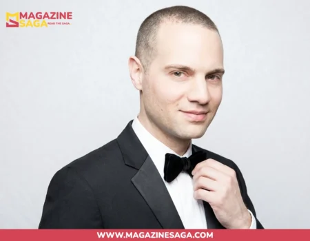 Jordan Roth in a black tuxedo and bow tie, formal studio portrait against a grey background