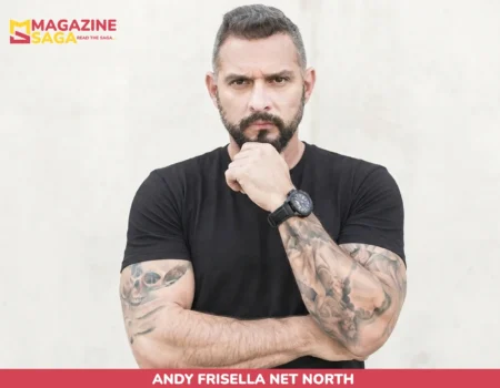 Andy Frisella net worth photo, bearded man in black shirt with tattooed forearms crossed