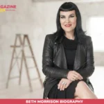 Beth Morrison biography portrait in black leather jacket, seated in a studio