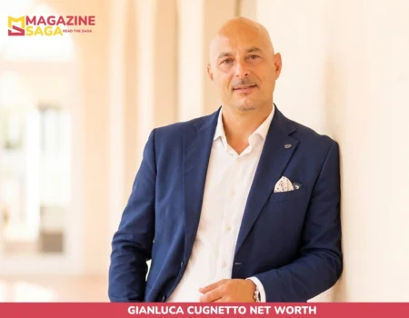 Gianluca Cugnetto net worth photo, hotelier in navy blazer standing in a sunlit hallway