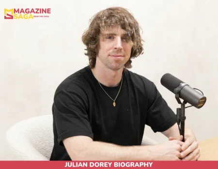 Julian Dorey biography photo, seated at studio microphone in black t-shirt