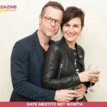 Guy Pearce and Kate Mestitz smiling together at an event, her arm around his waist