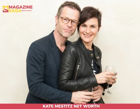Guy Pearce and Kate Mestitz smiling together at an event, her arm around his waist