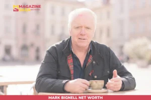 Mark Bignell sits at an outdoor café table holding a coffee cup for net worth article