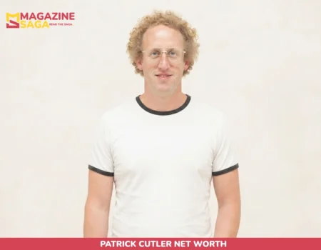 Patrick Cutler headshot, curly hair and glasses, white ringer tee, plain backdrop