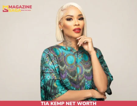 Tia Kemp Net Worth portrait, blonde bob, teal patterned kaftan, studio backdrop