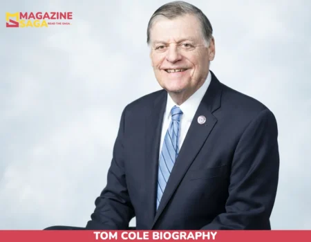Tom Cole Biography portrait, congressman smiling in navy suit and blue striped tie