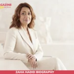 Zaha Hadid biography portrait, seated in cream suit against light backdrop