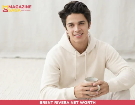 Brent Rivera smiling in cream hoodie holding mug, portrait for net worth article