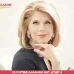 Christine Baranski net worth portrait, seated in a navy blazer with diamond earrings