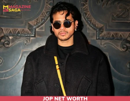 JOP net worth portrait in black coat and sunglasses against carved wall