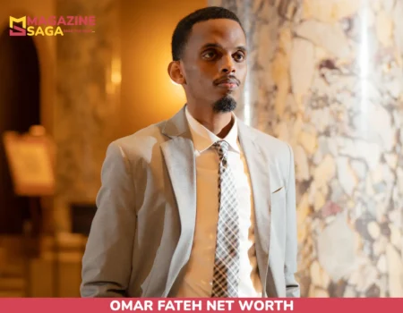 Omar Fateh net worth in a gray suit standing by marble columns for the article