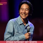 Henry Cho on-stage portrait with microphone for the net worth article