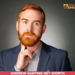 Andrew Santino in a navy blazer with hand raised to his chin, for the Andrew Santino net worth article