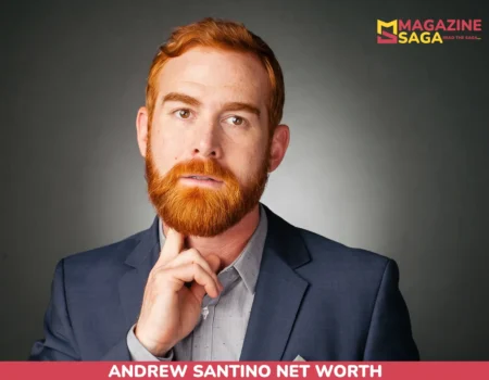 Andrew Santino in a navy blazer with hand raised to his chin, for the Andrew Santino net worth article