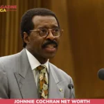 Johnnie Cochran net worth article portrait: man in gray suit and round glasses speaking at a podium
