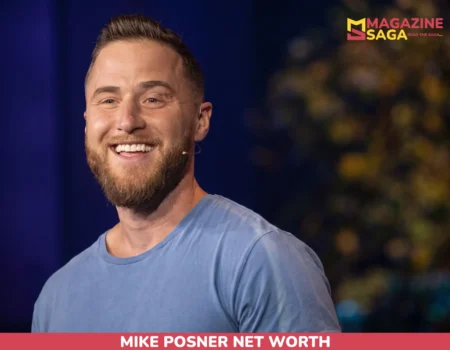 Mike Posner, bearded and smiling in a blue t-shirt with a headset microphone, for the Mike Posner net worth article