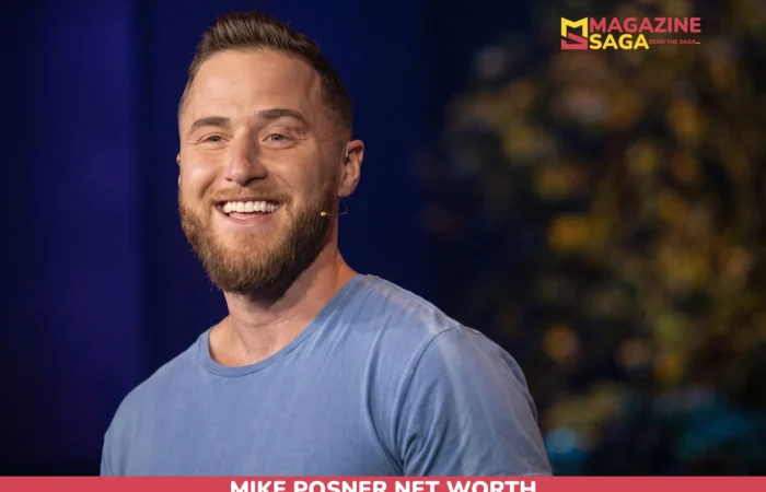 Mike Posner Net Worth 2026 – $10M Estimate, Grammy Nomination Mike Posner, bearded and smiling in a blue t-shirt with a headset microphone, for the Mike Posner net worth article