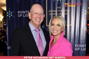 Peter McMahon net worth article photo: two people smiling in front of a navy event backdrop