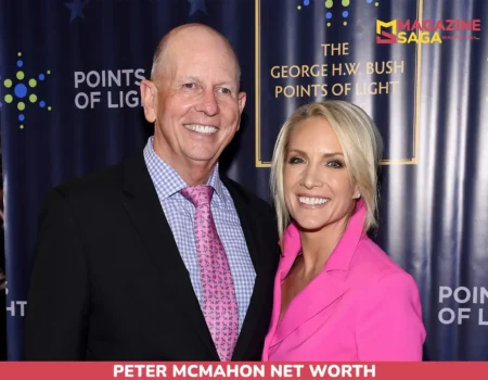 Peter McMahon net worth article photo: two people smiling in front of a navy event backdrop