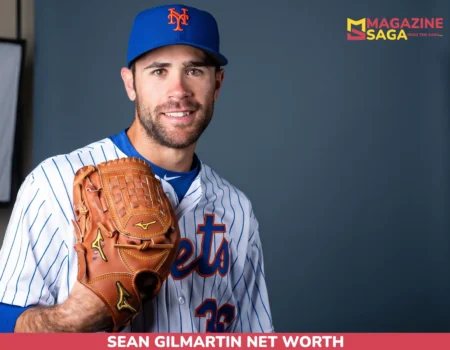 Sean Gilmartin net worth article portrait: smiling man in a Mets cap and pinstripe jersey holding a brown glove