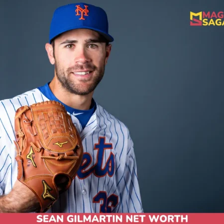 Sean Gilmartin net worth article portrait: smiling man in a Mets cap and pinstripe jersey holding a brown glove